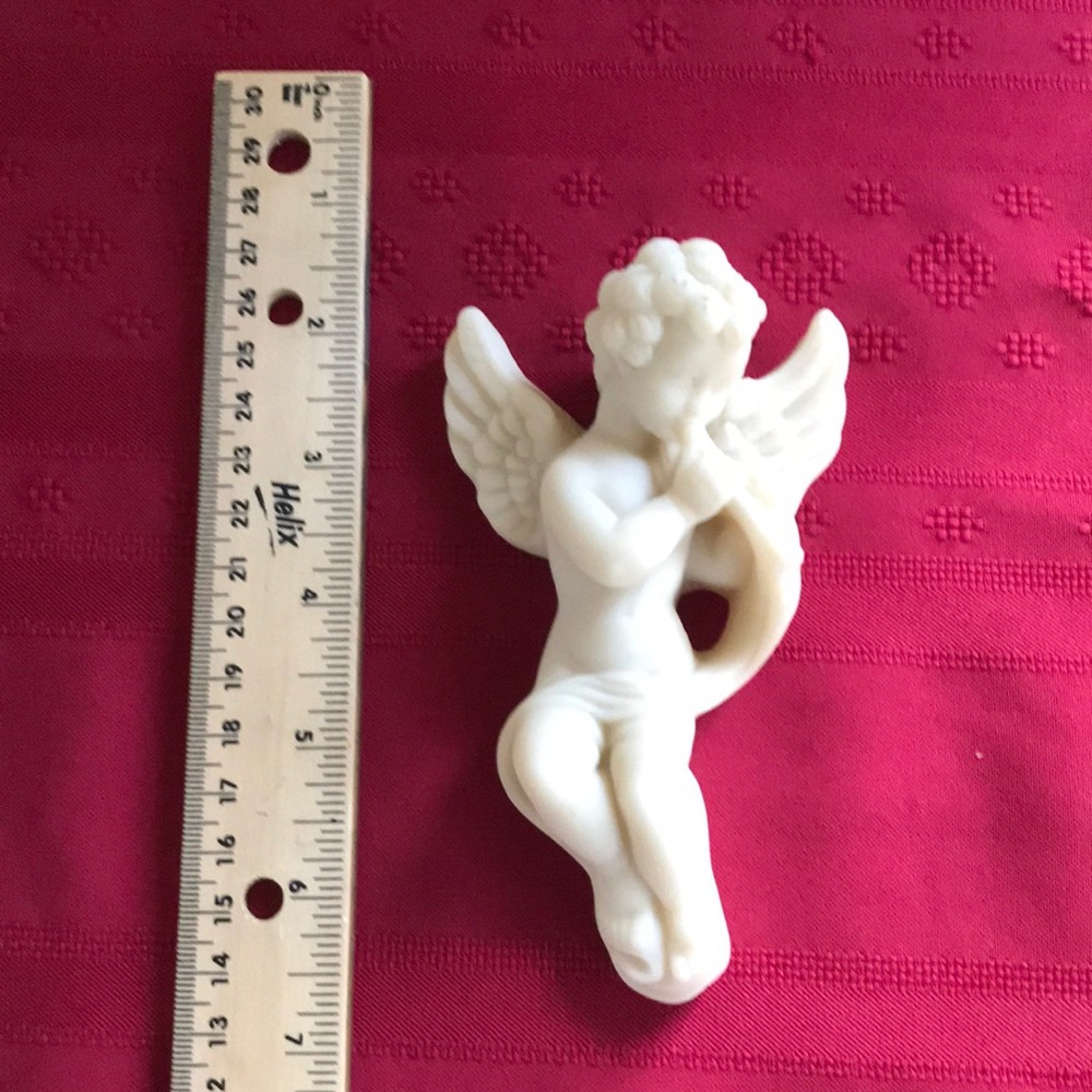 Cast marble cherub wall hanging